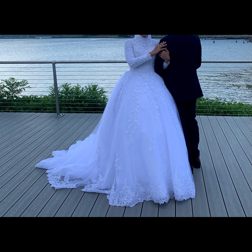 Custom wedding dress with a long train and the vail is included. Warren once